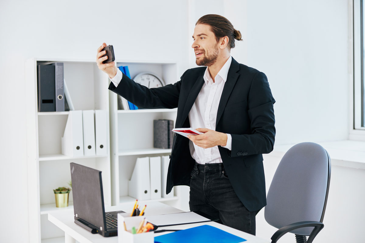 Office worker taking a photo in the office